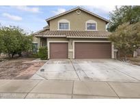 Two-story house with a two-car garage and landscaped front yard at 629 E Palo Verde St, Casa Grande, AZ 85122