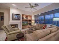 Cozy living room featuring a fireplace and comfortable seating at 7073 E Brilliant Sky Dr, Scottsdale, AZ 85266