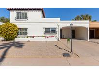 Spanish-style home with a carport and well-maintained landscaping at 7638 E Northland Dr, Scottsdale, AZ 85251