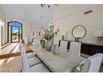 Bright dining room features a large table, modern light fixture, and access to backyard at 11585 N 108Th Way, Scottsdale, AZ 85259