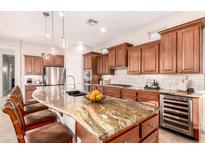 Gourmet kitchen features granite countertops, stainless steel appliances, and ample cabinetry at 1435 E Artemis Trl, Queen Creek, AZ 85140