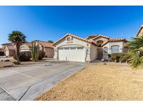 Single-story home with a two-car garage and desert landscaping at 15990 N 90Th Ave, Peoria, AZ 85382