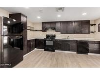 Modern dark kitchen with stainless steel appliances at 1983 E Don Carlos Ave, Tempe, AZ 85281
