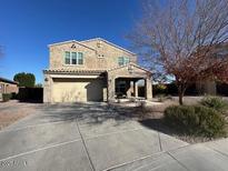 Two-story house with a three-car garage and landscaped front yard at 2776 E Mews Rd, Gilbert, AZ 85298