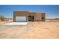 Contemporary single-story home featuring a neutral palette and eye-catching stone accents at 28615 N 257Th Dr, Wittmann, AZ 85361