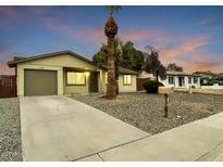 Single-story house with a landscaped yard, driveway, and attached garage at 3250 W Grovers Ave, Phoenix, AZ 85053