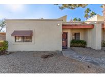 Tan stucco condo with red tile roof, walkway, and small front yard at 3535 W Monte Cristo Ave # 101, Phoenix, AZ 85053