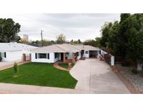 Charming single-story home with manicured lawn and spacious driveway, with brick accents on porch at 545 W Windsor Ave, Phoenix, AZ 85003