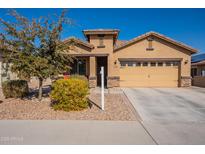 Single-story home with two-car garage and landscaped front yard at 105 S 224Th Ave, Buckeye, AZ 85326