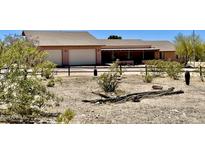 Ranch style home with two car garage and desert landscaping at 13602 S Garnet Rd, Buckeye, AZ 85326