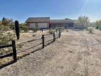 Ranch style home with a two car garage and a large yard at 13602 S Garnet Rd, Buckeye, AZ 85326