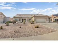 Single-story home with desert landscaping and a two-car garage at 22915 N Wagon Wheel Dr, Sun City West, AZ 85375