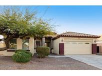 Charming single-story home with a two-car garage, mature tree, and desert landscaping at 2471 E Jade Dr, Chandler, AZ 85286