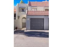 Townhouse exterior with a two-car garage and Spanish-style tile roof at 2524 S El Paradiso Dr # 70, Mesa, AZ 85202