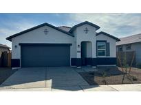 New single-story home with gray garage and landscaping at 39995 W Agave Rd, Maricopa, AZ 85138