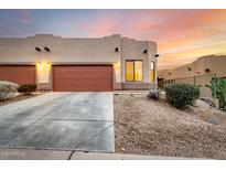 Two-car garage,desert landscaping, and sunset view at 6067 E Knolls S Way, Cave Creek, AZ 85331