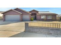 Single-story home with a two-car garage and solar panels at 7029 S 16Th Way, Phoenix, AZ 85042