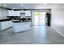 Modern kitchen with island and stainless steel appliances at 7150 W Montecito Ave, Phoenix, AZ 85033