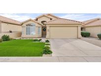 Beautiful desert home with artificial turf lawn and two-car garage at 7365 E Adele Ct, Scottsdale, AZ 85255