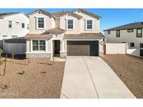 Two-story house with a large driveway and landscaped front yard at 7419 W Whitehorn Trl, Peoria, AZ 85383