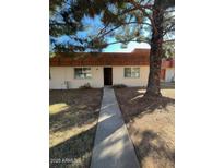 Front view of a condo with a walkway and mature tree at 7828 N 47Th Ave, Glendale, AZ 85301