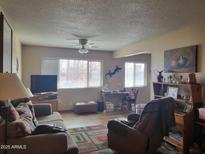 Living room with sofa, chair, and large window at 8210 E Garfield St # K213, Scottsdale, AZ 85257