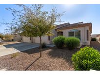 House exterior with two-car garage and desert landscaping at 10960 E Monte Ave # 223, Mesa, AZ 85209