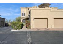 Tan two-story home with two-car garage and landscaped walkway at 11022 N Indigo Dr # 121, Fountain Hills, AZ 85268