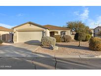 Single-story home with attached garage and desert landscaping at 1272 E Dust Devil Dr, San Tan Valley, AZ 85143