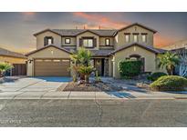 Two-story house with a three-car garage and landscaped front yard at 13611 W Merrell St, Avondale, AZ 85392