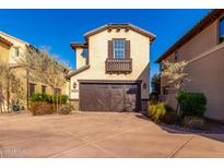 Tan three-story home with brown garage door and landscaping at 15913 S 11Th Way, Phoenix, AZ 85048