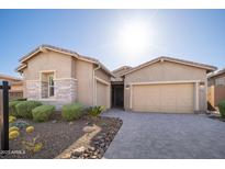 Inviting single-Gathering home featuring a three-car garage and desert landscaping at 23448 N 76Th Pl, Scottsdale, AZ 85255