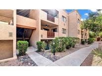 Attractive condo building exterior with landscaping and walkway at 3031 N Civic Center Plz # 317, Scottsdale, AZ 85251