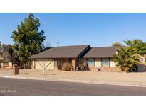 Single-story home with brick exterior, attached garage, and mature landscaping at 3910 W Michigan Ave, Glendale, AZ 85308