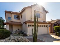 Two-story house with a two-car garage and desert landscaping at 4849 E Abraham Ln, Phoenix, AZ 85054