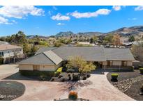 Single-story home with a brick driveway and mountain views at 5213 W Soft Wind Dr, Glendale, AZ 85310