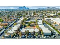 Aerial view of an apartment complex with a pool, tennis court, and ample parking at 5877 N Granite Reef Rd # 1160, Scottsdale, AZ 85250