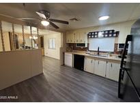 Kitchen with white cabinets, dark countertops, and LVP flooring at 8103 E Southern Ave # 84, Mesa, AZ 85209