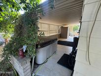 Covered patio with hot tub and storage shed at 8103 E Southern Ave # 84, Mesa, AZ 85209