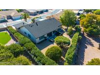 Aerial view of a home with a spacious backyard, lush landscaping, and a patio at 814 S 78Th St, Mesa, AZ 85208