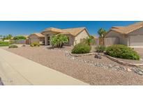 Single-story home with desert landscaping and a two-car garage at 9555 W Escuda Dr, Peoria, AZ 85382