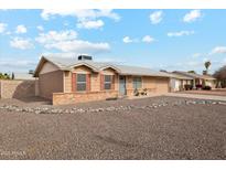 Tan one-story house with rock landscaping and a two-car garage at 10572 W Echo Ln, Peoria, AZ 85345