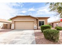 Charming single-story home featuring a two-car garage, well-maintained landscaping, and a welcoming entrance at 2077 W Tanner Ranch Rd, San Tan Valley, AZ 85144