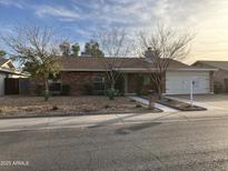 Brick ranch house with landscaped yard and attached two-car garage at 3001 W Villa Maria Dr, Phoenix, AZ 85053