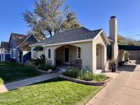 Charming single-story home with a well-manicured lawn and inviting front porch at 305 W Lewis Ave, Phoenix, AZ 85003