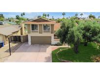 Two-story home featuring an attached garage, well-maintained lawn, and mature tree in a quiet neighborhood at 4615 W Boston St, Chandler, AZ 85226