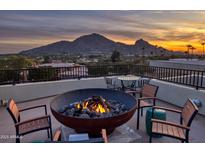 Relax on this rooftop patio with a fire pit, mountain views, and an outdoor seating area perfect for entertaining at 5826 E Indian Bend Rd, Paradise Valley, AZ 85253