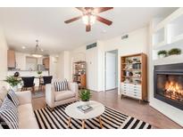 Bright living room with fireplace, hardwood floors, and stylish furniture at 6535 E Superstition Springs Blvd # 124, Mesa, AZ 85206