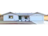 Charming single-story home with well-maintained landscaping, a covered porch, and an attached two-car garage at 8129 E Meseto Ave, Mesa, AZ 85209