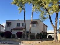 Two-story stucco building with red tile roof, landscaping, and a paved walkway at 8861 N 12Th Pl, Phoenix, AZ 85020